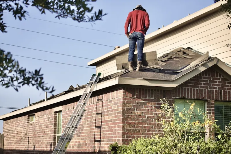 Professional roofer working on a residential roof in Brookville